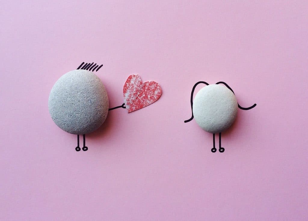 Cute handiwork using pebbles to depict a boy wooing a girl