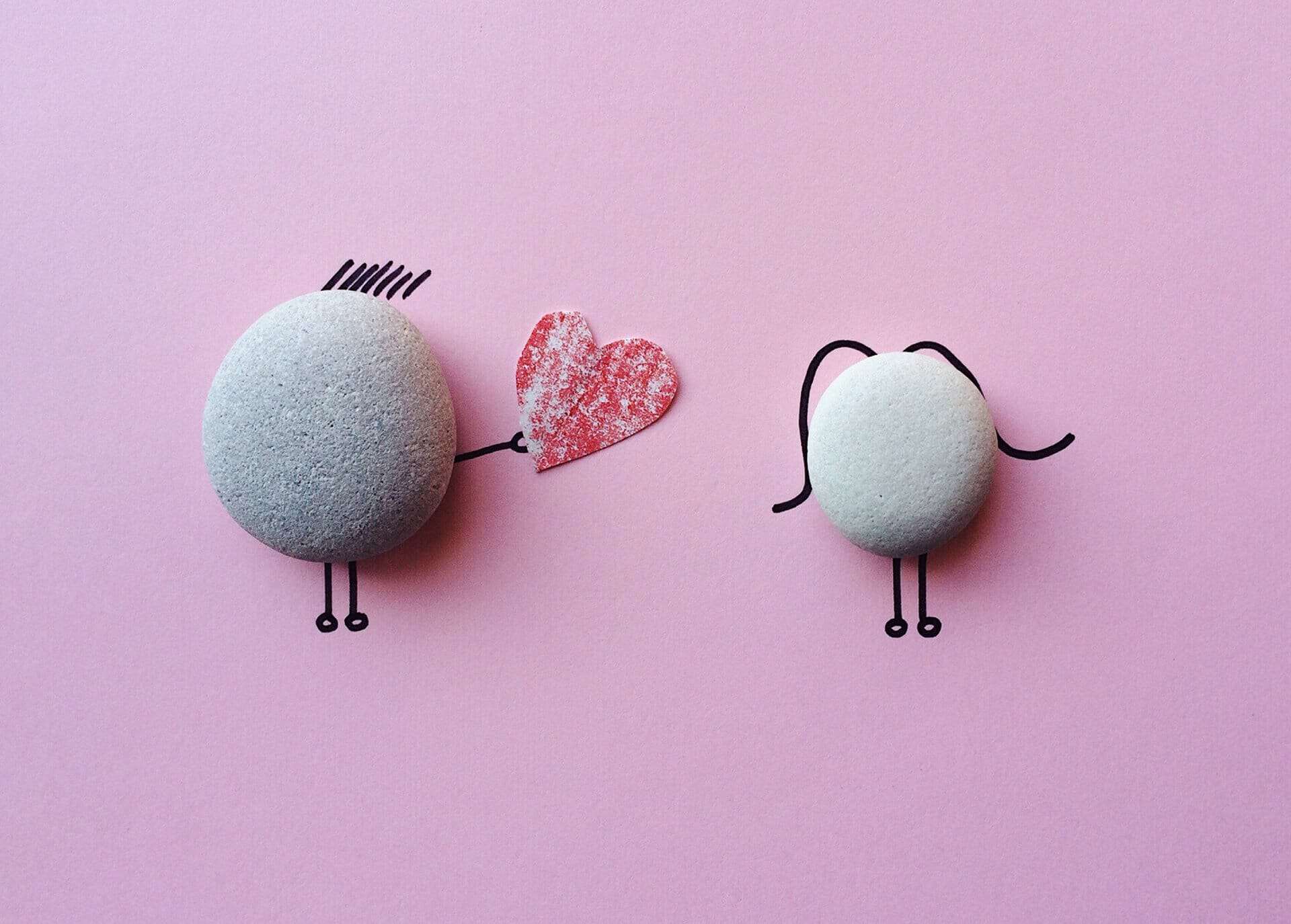Cute handiwork using pebbles to depict a boy wooing a girl