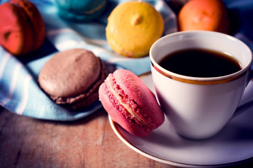 Macaroon cookies and cup of coffee,selective focus and low key