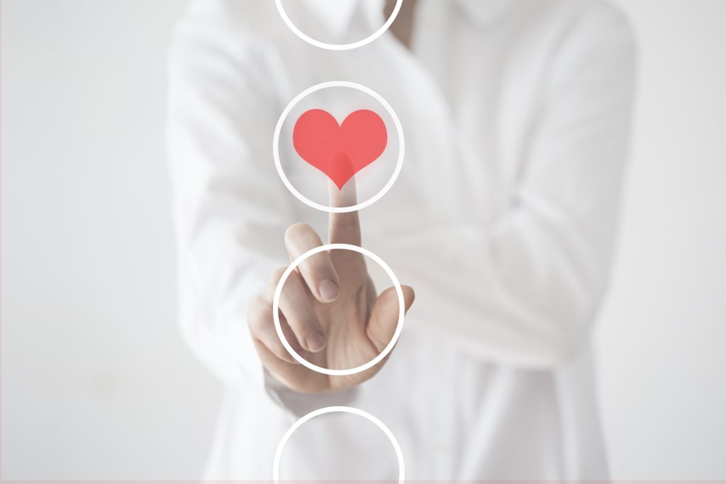 Woman touching heart icon.