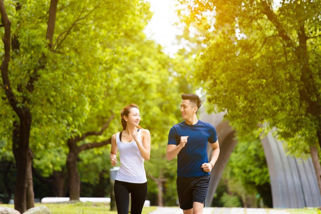 man and woman jogging togethe