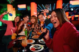 girl sings with groups of friends in a karaoke room image